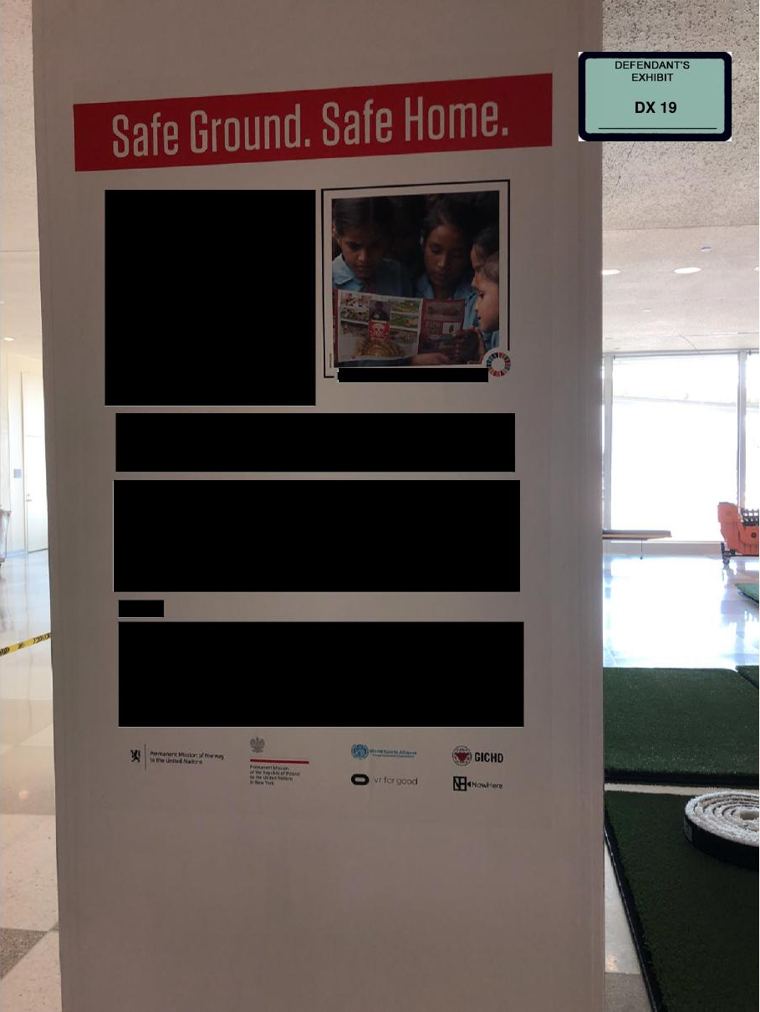 The UN sign in the lobby, as shown at trial, with its bottom line redacted.