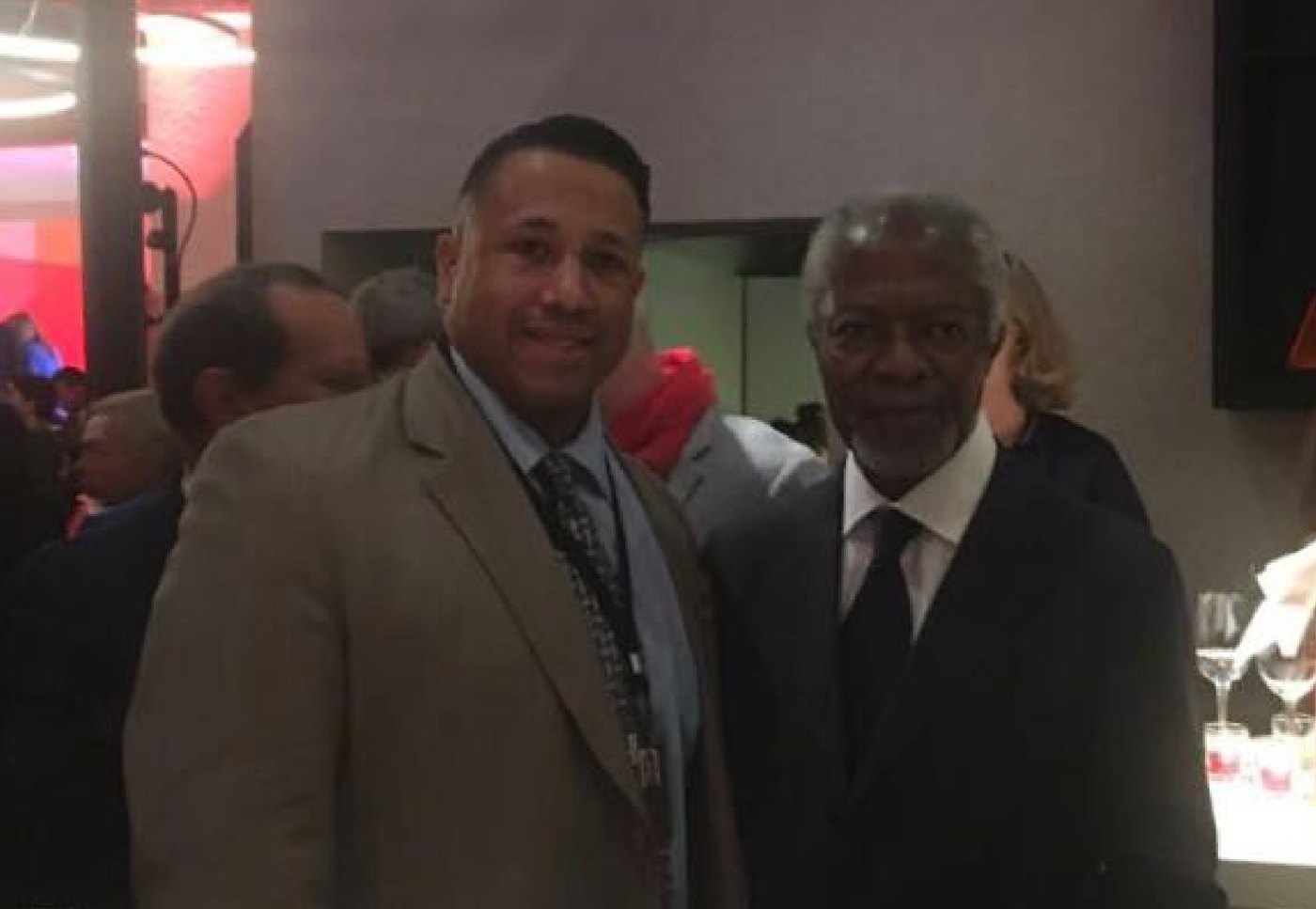 Asa Saint Clair standing beside Kofi Annan at a dinner in Davos.